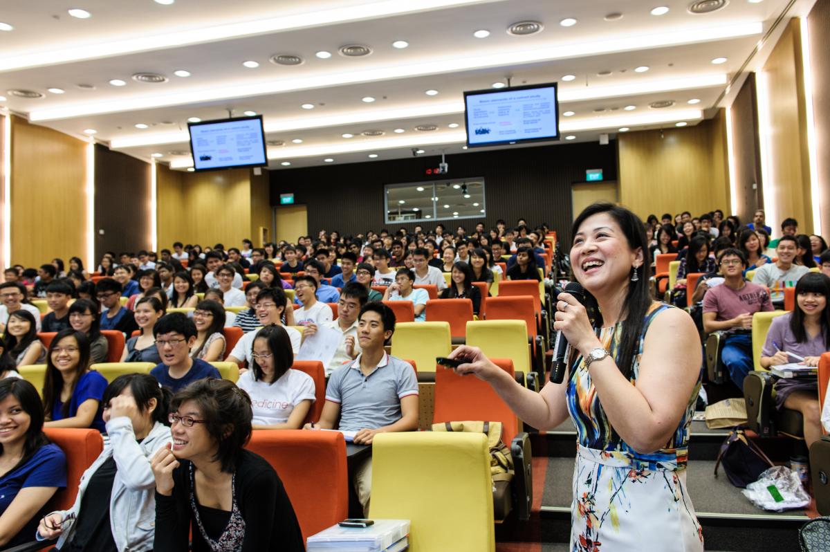 a professor teaching in a crowded lecture hall