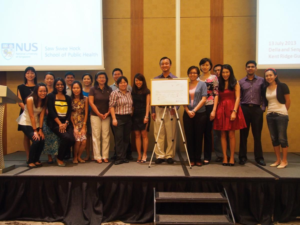 Dean Prof Chia Kee Seng with the graduating batch of MPH and PhD students on stage after the signing of the Public Health pledge.