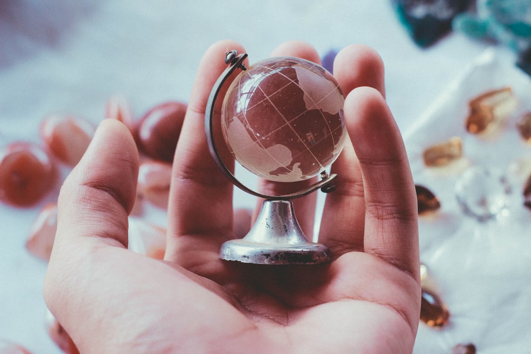 Miniature globe in hand