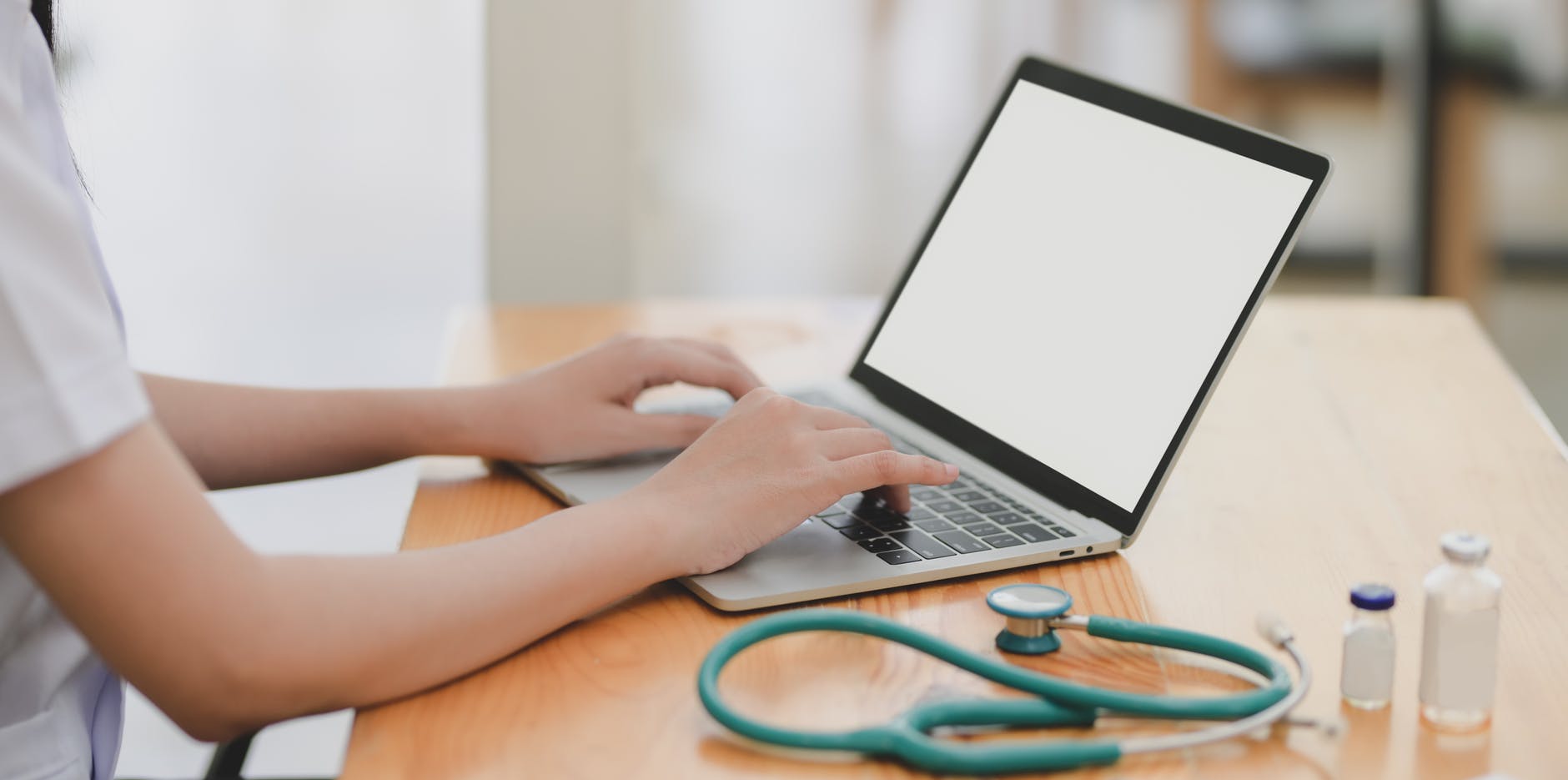 Stethoscope next to a laptop