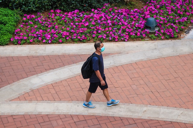 Man wearing mask and walking
