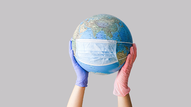 gloved hands carrying a globe