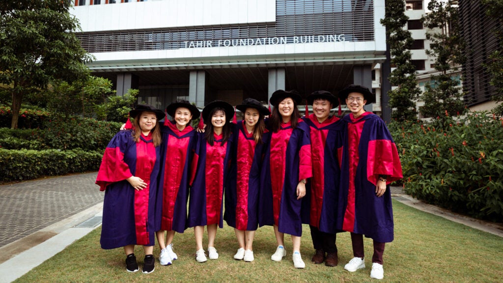 Cheng Ling Jie with fellow graduates outside the Tahir Foundation Building, home of the School.