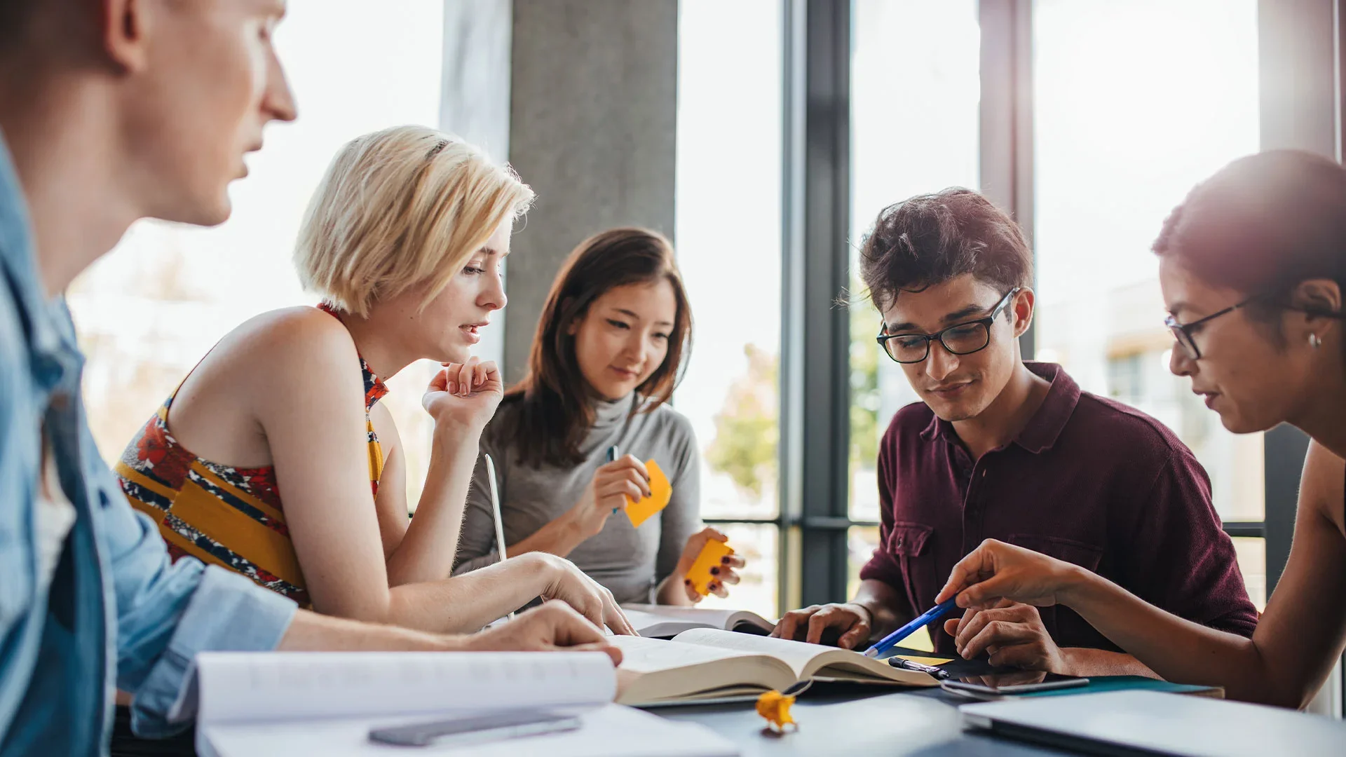 Diverse-group-of-students-studying-at-library