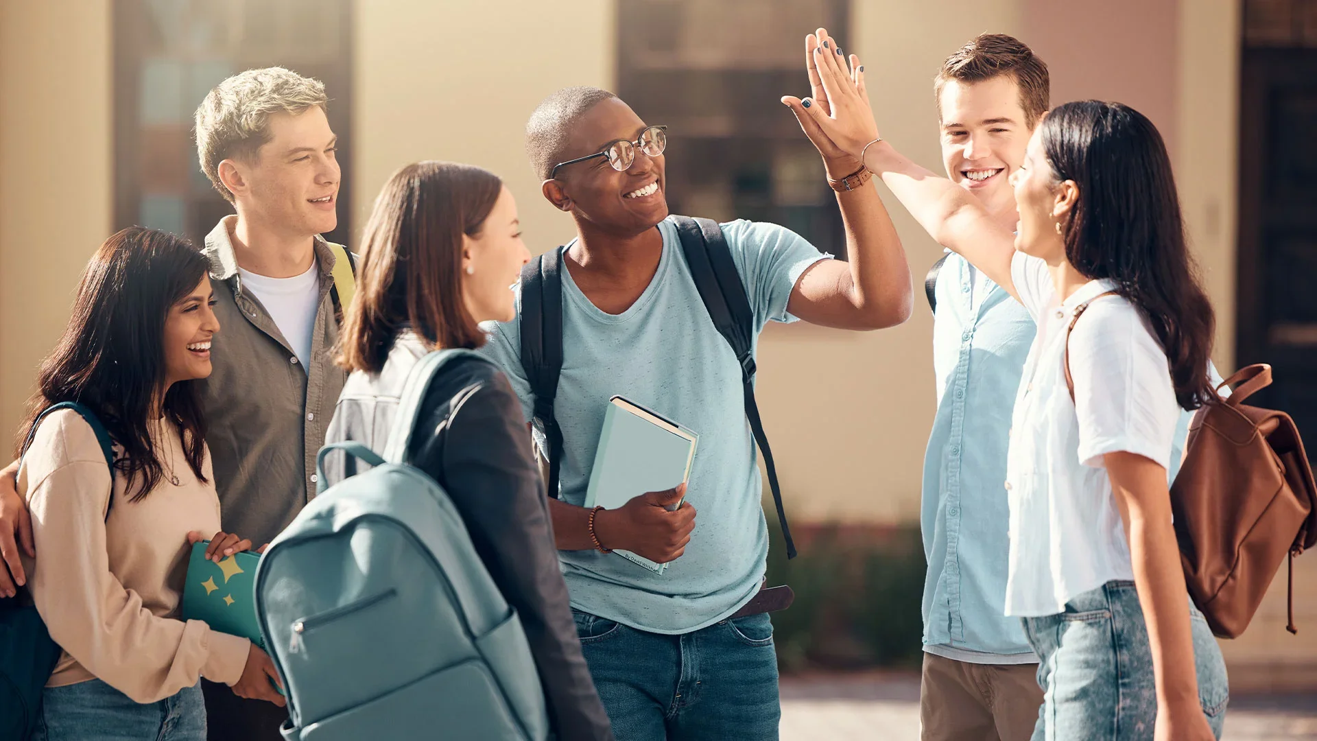 Student-high-five-of-diversity-college